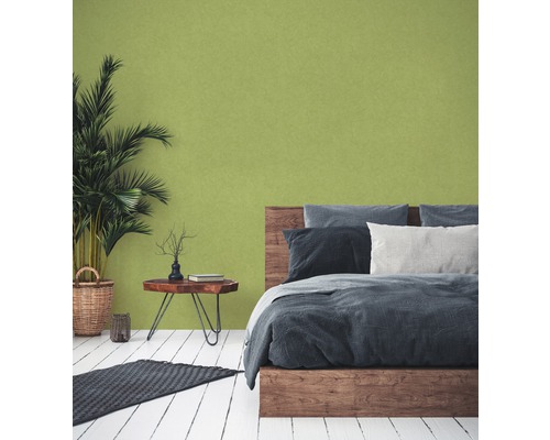 Schlafzimmer mit Doppelbett, Holzboden und Zimmerpflanze im Korb