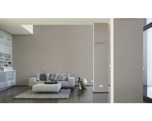 Wohnzimmer mit Sofa, Sessel und Regalen für ein helles Ambiente