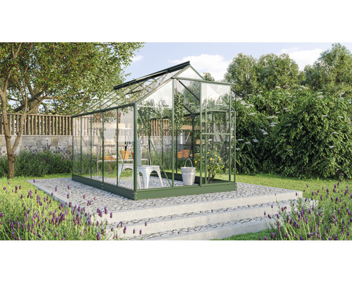 Gewächshaus im Garten mit Pflanzen und Gartengeräten
