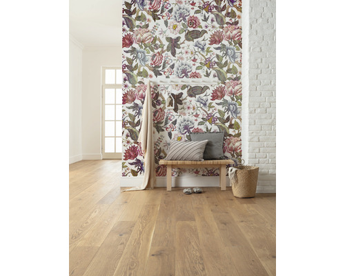 Heller Raum mit floraler Tapete, Holzboden, Sitzbank und Dekorationen.