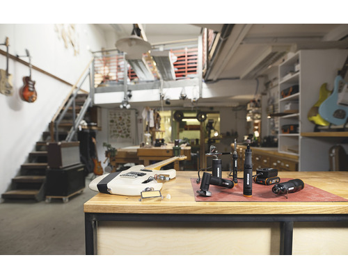 Werkstatt-Szene mit einer E-Gitarre und mehreren rotierenden Werkzeugen der Marke Worx