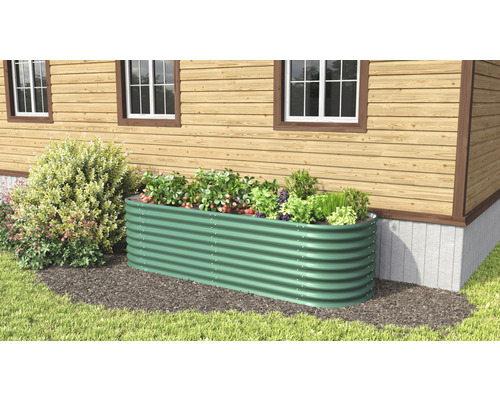 Hochbeet aus Metall im Garten vor einem Haus.