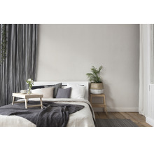 Schlafzimmer mit Bett, Kissen, Decke, Vorhängen und Pflanzen