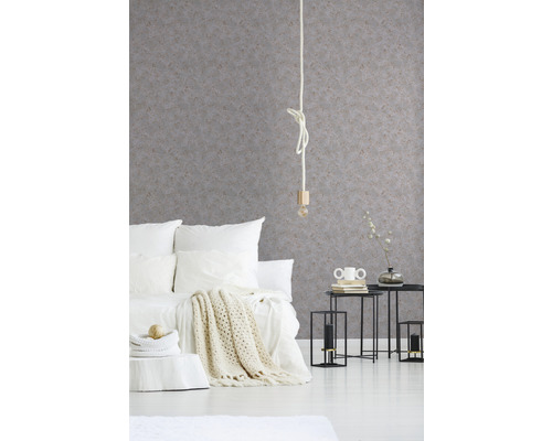 Schlafzimmer mit strukturierten Tapeten, Bett und Beistelltischen.