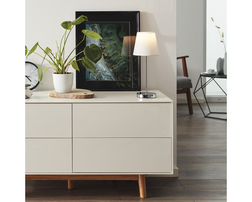 Modernes Wohnzimmer mit Kommode, Tischleuchte und Dekorationsgegenständen