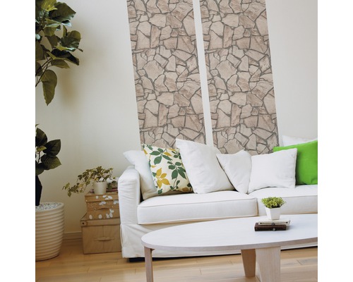 Wohnzimmer mit Steintapete, Sofa und Tisch für ein helles Ambiente.