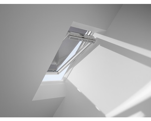 Geöffnetes Dachfenster mit Rollo in einem hellen Raum