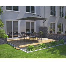 Terrasse mit Gartentisch, Stühlen und Sonnenschirm vor einem Haus