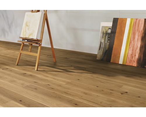 Helle Holzbodenfläche mit Staffelei und Bildern