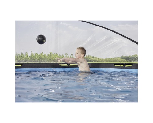 Junge spielt mit einem Ball im Swimmingpool.