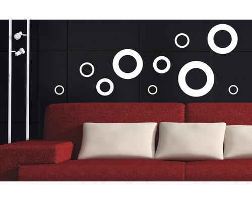 Dekoratives Wohnzimmer mit Wandtattoos in Form von Kreisen über einem roten Sofa