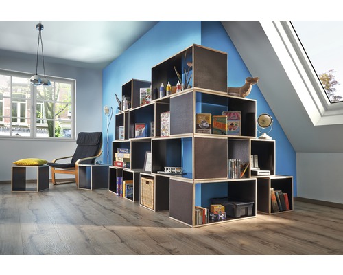 Wohnzimmer mit modularem Regalsystem, Sessel und Dachfenster