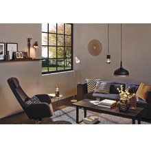 Wohnzimmer mit Sofa, Sessel, Tisch, Stehlampe, Pendelleuchten und dekorativer Wanduhr