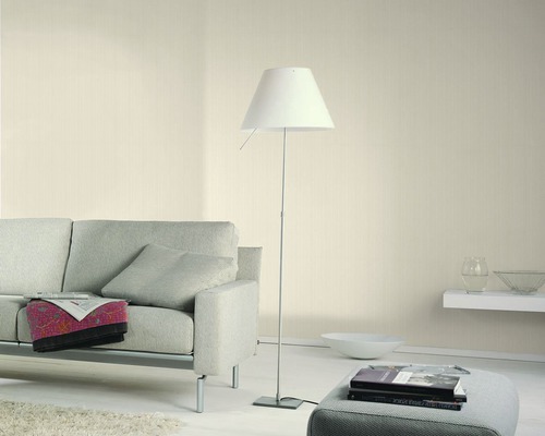 Wohnzimmer mit Sofa, Stehlampe und Dekorationen für eine helle und organisierte Atmosphäre.