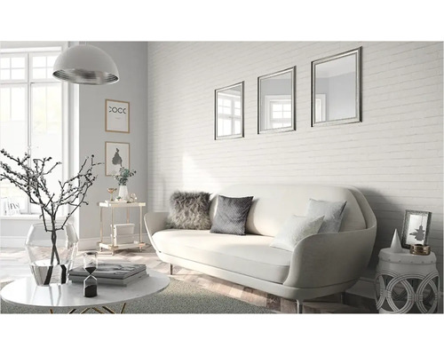 Wohnzimmer mit Sofa, Couchtisch und dekorativen Accessoires vor einer Ziegelwand