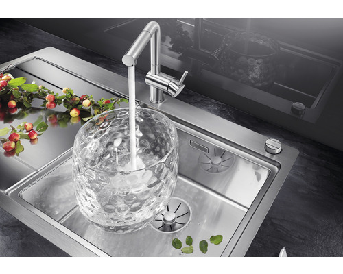 Edelstahlspüle mit Wasserhahn und Glasgefäß