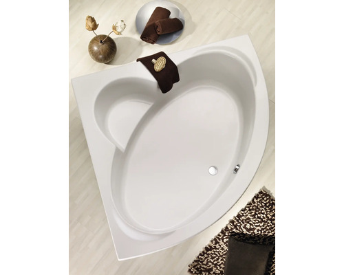 Eckbadewanne im Badezimmer mit Handtüchern und Badematte