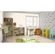 Kindgerechtes Zimmer mit Möbeln, Spielsachen und einer bunten Spielmatte.