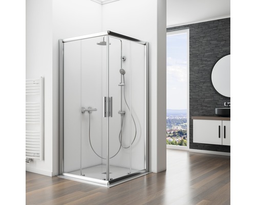 Eckdusche mit Glastüren und Duschgarnitur in einem Badezimmer mit Waschbeckenunterschrank und Spiegel.