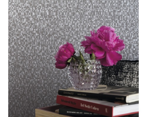 Nahaufnahme einer strukturierten Tapete mit Blumenarrangement und Büchern