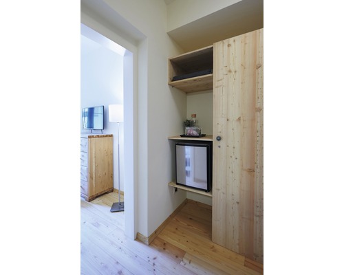 Innenraum mit Holzschrank, Minibar und Fernseher