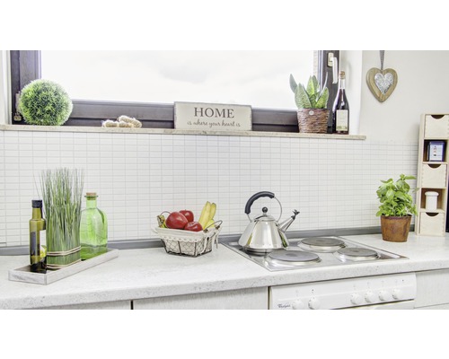 Helle Küche mit Obst, Teekessel und Dekoration auf der Arbeitsfläche