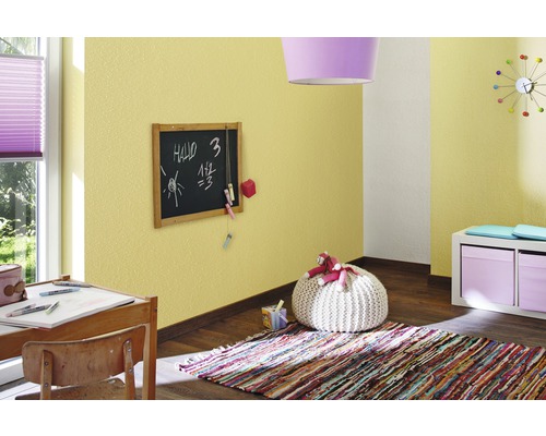 Kinderzimmer mit Schreibtisch, Tafel, Teppich und gelber Strukturtapete.