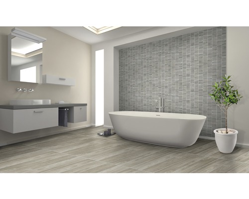 Badezimmer mit Badewanne, Waschtisch, Spiegel und grauen Fliesen