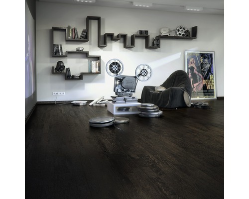 Wohnzimmer mit dunklem Holzboden, Projektor, Bücherregal und Filmposter