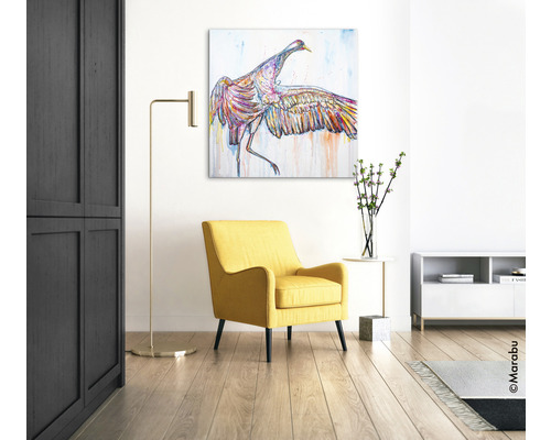 Wohnzimmer mit gelbem Sessel, Stehlampe und Wandbild eines Vogels