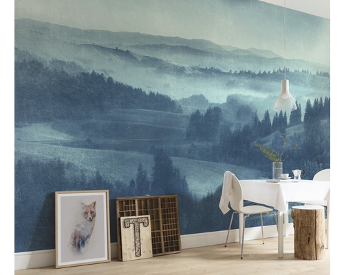 Wohnraum mit Fototapete einer Berglandschaft, Esstisch und Dekoration