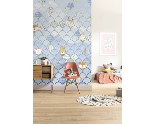 Kinderzimmer mit Tapete im Schuppendesign und Tiermotiven, dekoriert mit Möbeln und Spielsachen.
