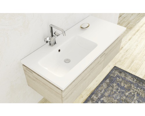 Waschbecken mit Armatur und Unterschrank im Badezimmer.