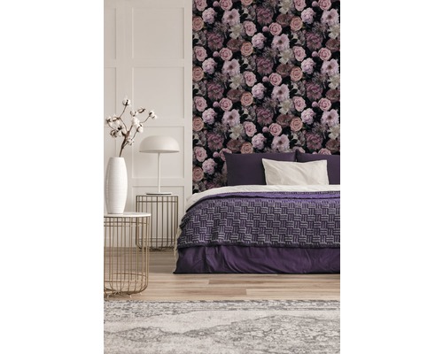 Schlafzimmer mit floral gemusterter Tapete und lila Bettwäsche