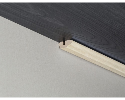 Bodenabschlussleiste aus Holz am dunklen Bodenbelag