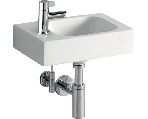 Weißes Aufsatzwaschbecken mit Chromarmatur und Siphon
