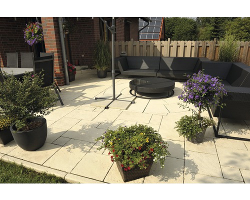 Terrasse mit Gartenmöbeln, Pflanzen und Steinplatten