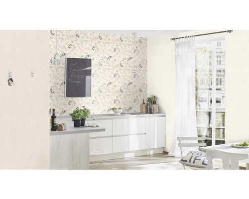 Heller Küchenraum mit gemusterter Tapete, weißen Schränken und Esstisch am Fenster.