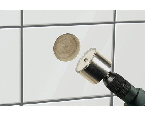 Fliesenlochbohrer im Einsatz mit herausgeschnittenem Fliesenteil