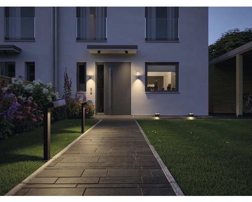 Beleuchteter Gartenweg zu einem modernen Haus mit Außenbeleuchtung