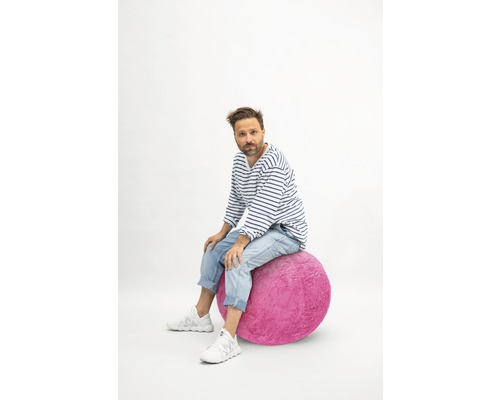 Mann sitzt auf Gymnastikball