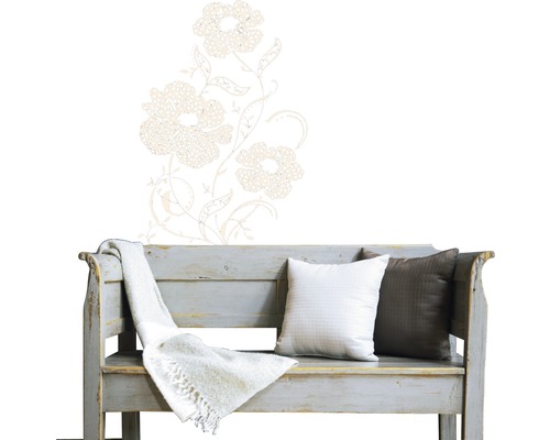 Dekoratives Blumen Wandtattoo über einer Holzbank mit Kissen und einer Decke