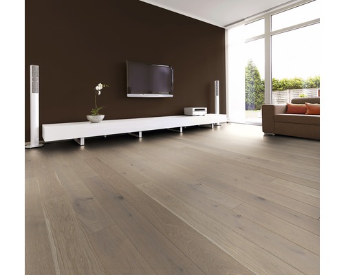 Wohnzimmer mit Holzboden, Fernseher und Sofa