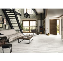 Helles Wohnzimmer mit Treppe, Kaminofen, Sofa und Holzbodenfliesen