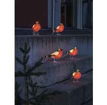 Dekorative beleuchtete Vogel Figuren auf einer Steintreppe.