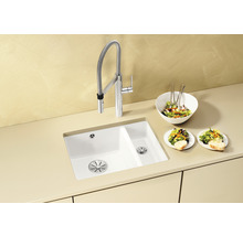 Küchenspüle mit Armatur und Salatzubereitung auf der Arbeitsfläche