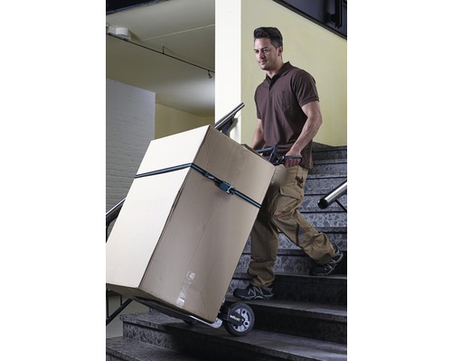 Mann transportiert Karton mit Treppenkarre über eine Treppe