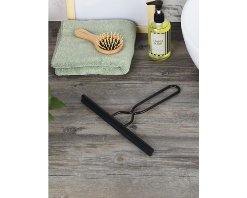 Schwarzer Duschabzieher auf Holzgrund