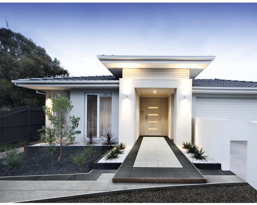 Modernes Haus mit gepflastertem Weg zum Eingang