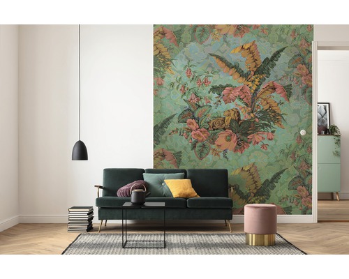 Wohnzimmer mit grüner Couch, floraler Tapete und Hängelampe